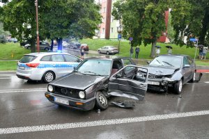 Zdjęcie przedstawia zdarzenie drogowe oraz radiowóz policyjny.