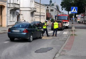 Zdjęcie przedstawia zdarzenie drogowe oraz policjantów.