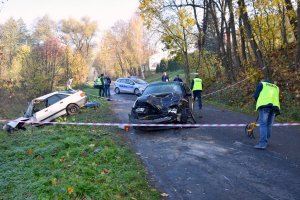 Zdjęcie przedstawia zdarzenie drogowe dwóch samochodów osobowych oraz policjantów pracujących na miejscu zdarzenia.