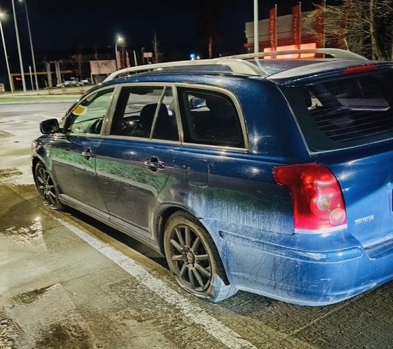 samochód toyota koloru niebieskiego widoczny z lewej strony stojący na zatoczce